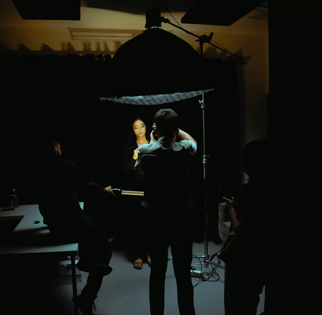 A man is positioned in front of a light source clicking pictures